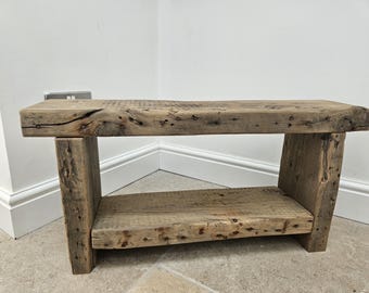 A vintage rustic console bench crafted from aged reclaimed beams.