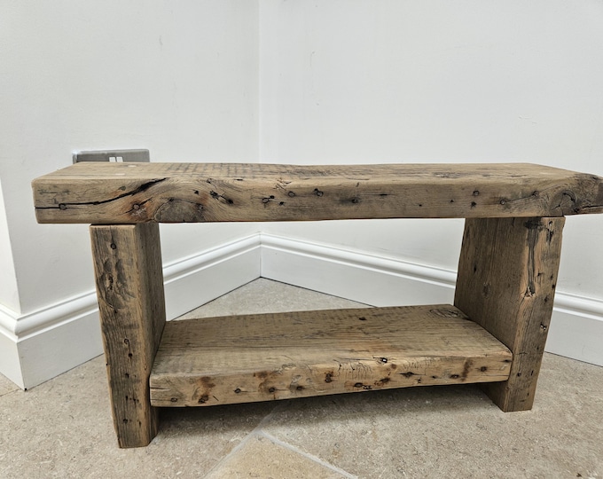 A vintage rustic console bench crafted from aged reclaimed beams.