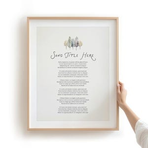 May include: A framed print featuring a watercolor illustration of a small cluster of trees at the top, followed by the text "Song Title Here" and several paragraphs of placeholder text in a black serif font on a light cream background.
