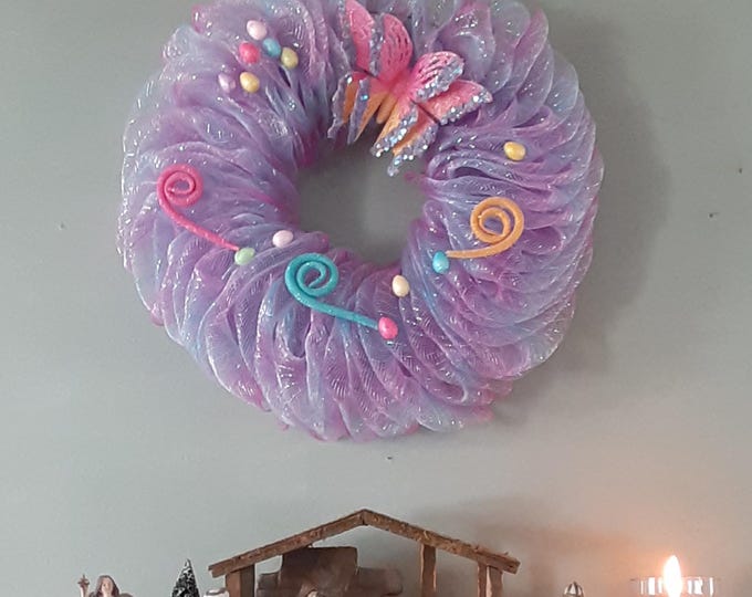 Deco Mesh Wreath with Butterfly, Mini Eggs, and Whimsical colored swirls. colorful spring door decor, handmade spring or garden wreath