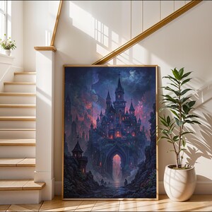 May include: A framed art print of a fantasy castle with tall spires and glowing windows, set against a dramatic, colourful sky. The artwork is in a wooden frame and leans against a white wall, next to a potted plant.