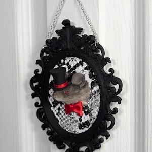 May include: A set of three ceramic mugs with a speckled, matte finish. The mugs are in shades of cream, light gray, and dark gray. Each mug has a simple, minimalist design, perfect for coffee or tea.