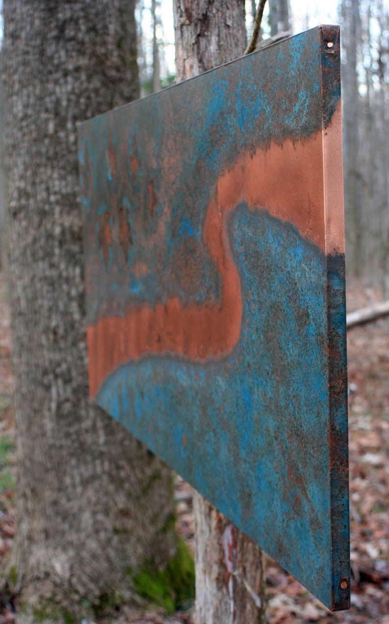 May include: A large, rectangular metal panel with a blue and copper patina. The panel has a unique, abstract design with a flowing, organic shape.