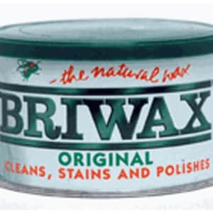 May include: A white can with a green lid and green lettering that reads "BRIWAX ORIGINAL CLEANS, STAINS AND POLISHES". The can has a small image of a bee on the top left corner and the text "the natural food" in red cursive.