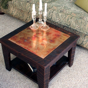 Small Copper Coffee Table w/ Shelf. Flame Painted Copper Top Table. Rustic Copper Coffee Table. 24&quot; l x 24&quot; w x 17&quot; t. Dark Brown Finish.