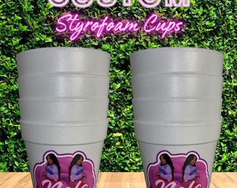 May include: Two white Styrofoam cups with a custom design. Each cup features a pink and purple label with the text "Nola Rose" and an image of two women. The background includes the text "CUSTOM Styrofoam Cups".