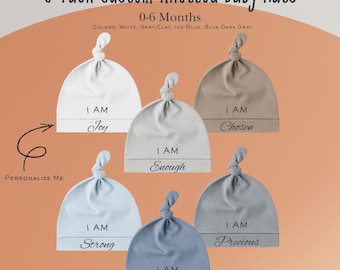 May include: A 6-pack of custom knotted baby hats in various colors, including white, gray, and blue. Each hat features the words "I AM" followed by a positive affirmation like "Joy" or "Precious". Designed for babies aged 0-6 months.