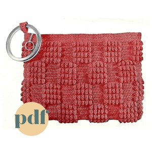 May include: A red crocheted bag with a metal ring handle. The bag is made with a textured stitch and has a fringed edge. The bag is a vintage style and is perfect for carrying small items.