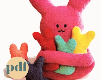 May include: A pink bunny plush toy with embroidered eyes and a smiling mouth. The bunny is holding three smaller bunny plush toys in different colors: red, green, and yellow. The text "preserve" is at the top of the image and "pdf" is at the bottom of the image.