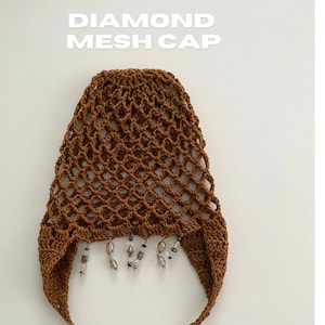 May include: A brown crochet mesh cap with dangling beads and a tie closure. The cap features a diamond mesh pattern and the text "DIAMOND MESH CAP" and "CROCHET PATTERN". The cap is a handmade accessory.