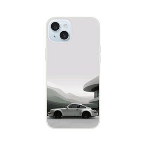 Może przedstawiać: Białe etui na iPhone z fotografią srebrnego Porsche 911 jadącego po drodze z nowoczesnym budynkiem w tle.
