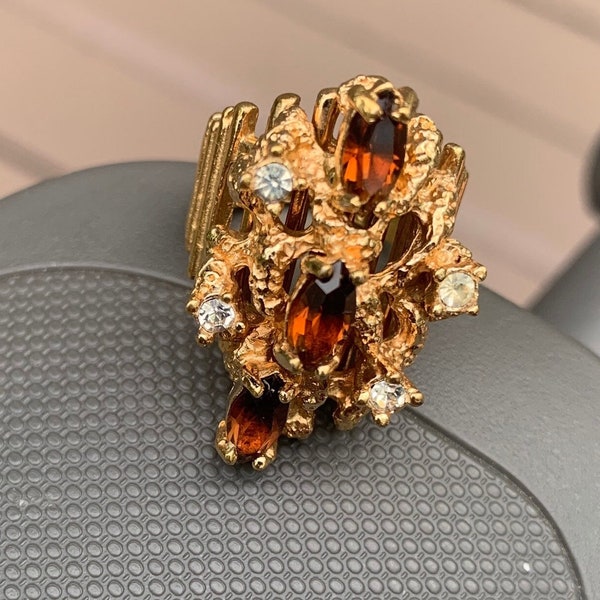 14kt heavy gold electroplate garnet color  and white faceted stones. Very sparkly dinner,cocktail ring. Size 6 never worn vintage.