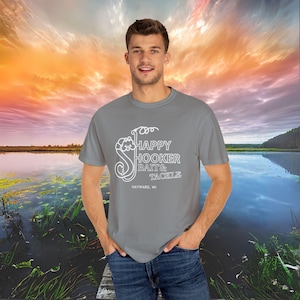May include: A gray t-shirt with a white graphic of a fish and the text "Happy Hooker Bait & Tackle Hayward, WI".