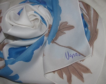 May include: White silk scarf with a blue floral design and the word "Usma" in purple lettering.