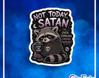 May include: A die-cut sticker featuring a gray and black raccoon wearing a black hoodie with a skull graphic. The raccoon holds a mug labeled LEAVE ME ALONE. Text reads NOT TODAY, SATAN and I'M OVER-STIMULATED ENOUGH ALREADY. Includes small skull icons.