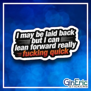 May include: A white sticker with the text "I may be laid back but I can lean forward really fucking quick" in black, white, and red. The sticker has a black border and is set against a blue background. The brand name "GinEric STICKERS" is at the bottom.