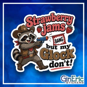 May include: A die-cut sticker featuring a cartoon raccoon dressed as a cowboy with a hat, vest, and boots. The raccoon holds a blue toy gun with a red flag that says BANG. Text reads Strawberry jams but my Glock don't with two strawberries.