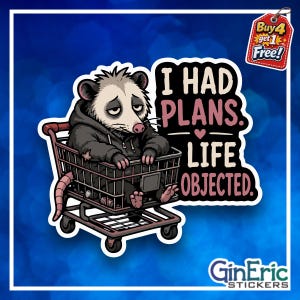 May include: A die-cut sticker featuring a tired-looking opossum wearing a dark gray hoodie, sitting inside a brown shopping cart. The text reads I HAD PLANS. LIFE OBJECTED. A small red tag in the corner says Buy 4 get 1 Free and GinEric STICKERS.