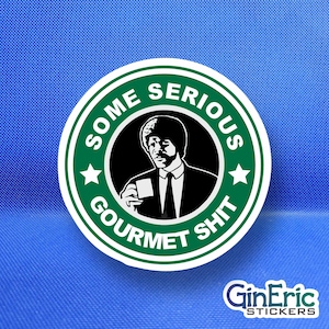 May include: A round sticker with a green and white design. The sticker features a black and white image of a man holding a cup, surrounded by the words "SOME SERIOUS GOURMET SHIT." The sticker has a white border and two white stars.