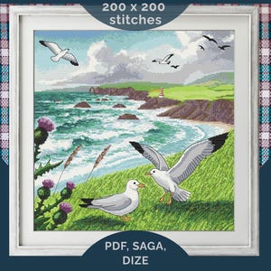 May include: Cross-stitch picture depicting a coastal landscape with seagulls, a lighthouse, and ocean waves. The framed artwork shows a vibrant scene with green grass, purple thistles, and the text "200 x 200 stitches" and "PDF, SAGA, DIZE".