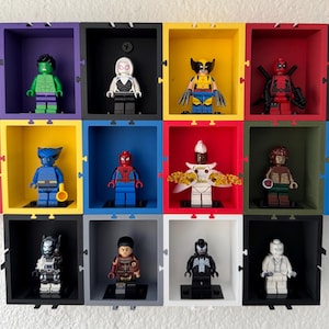 May include: A wall display with 10 small black frames, each containing a different Lego minifigure. The minifigures are all Marvel characters, including Spider-Man, Wolverine, Deadpool, and Storm.