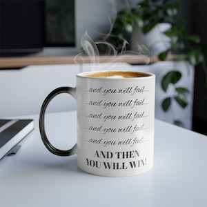 May include: White ceramic coffee mug with a black handle. The mug has a motivational quote that reads: "...and you will fail... ...and you will fail... ...and you will fail... ...and you will fail... ...and you will fail... AND THEN YOU WILL WIN!"