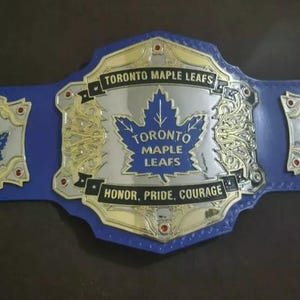 New World Toronto Maple Leaf Schwergewichts-Meisterschaft Wrestling Gürtel Gravurmaterial mit hochwertigem Lederriemen