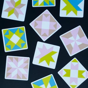 ini quilt block sticker set of 10 featuring bold geometric star and block designs in either bold and bright or soft and neon colorways. Each 1"x1" sticker is individually cut and packed. Waterproof vinyl, gloss laminated. Sticks to water bottles, laptops, planners, and sewing machines. The collector's set for the modern quilter — perfect for quilt retreat goodie bags and guild gifts.
