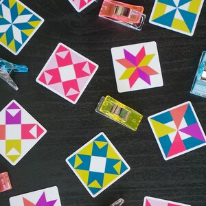 ini quilt block sticker set of 10 featuring bold geometric star and block designs in either bold and bright or soft and neon colorways. Each 1"x1" sticker is individually cut and packed. Waterproof vinyl, gloss laminated. Sticks to water bottles, laptops, planners, and sewing machines. The collector's set for the modern quilter — perfect for quilt retreat goodie bags and guild gifts.