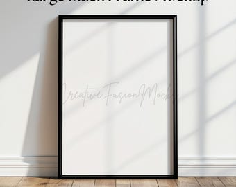 May include: A large black frame mockup on a white wall with wood flooring. The frame is empty and ready for your design.