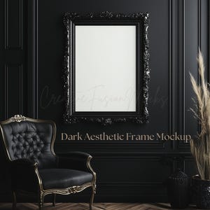 May include: A black ornate frame with a white background, sitting on a black wall with gold trim. A black armchair with gold accents sits in the foreground. The text "Dark Aesthetic Frame Mockup" is written below the frame.