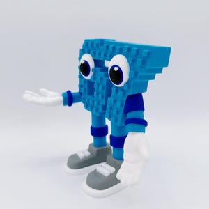 May include: A blue, pixelated character with large white eyes and outstretched white hands. The figure has blue arms and legs, wearing gray sneakers with white soles. The character is a whimsical, 3D-printed figurine.