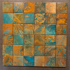 May include: A grid of thirty-six square tiles featuring a weathered, oxidized metal finish. Each tile displays a unique blend of metallic copper, bronze, and earthy brown tones contrasted with vibrant, mottled patches of turquoise and teal patina.