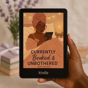 May include: A black Kindle e-reader displaying an illustration of a person relaxing in bed with the text "CURRENTLY Booked & UNBOTHERED" and the brand name "kindle". The image has a warm, inviting color palette.
