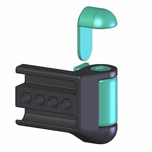 May include: A black and teal mechanical component with a curved, rectangular base and a cylindrical body. The component has a teal-colored, curved top piece that is detached. The base features four hexagonal indentations.