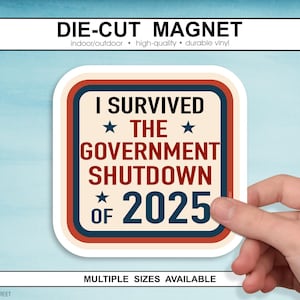May include: A die-cut magnet with the text "I SURVIVED THE GOVERNMENT SHUTDOWN OF 2025". The magnet has a cream background with red, white, and blue accents. The text is in a bold, retro font.