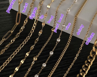May include: A collection of gold-colored necklaces in various styles, including paperclip, twist, figaro, lip, bead, pearl bead, vine, dainty, and cuban chains. Each chain is displayed individually, showcasing its unique design and texture.