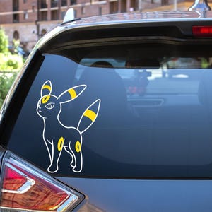 May include: A white outline of a black and yellow Pokemon character on a gray car window.