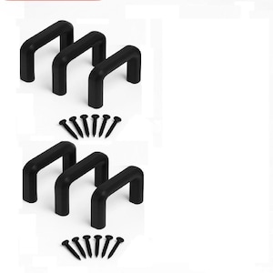 May include: A collection of black U-shaped cabinet handles, accompanied by screws. The handles are constructed from a solid material. The image displays two sets of handles and screws, suitable for furniture or cabinetry.