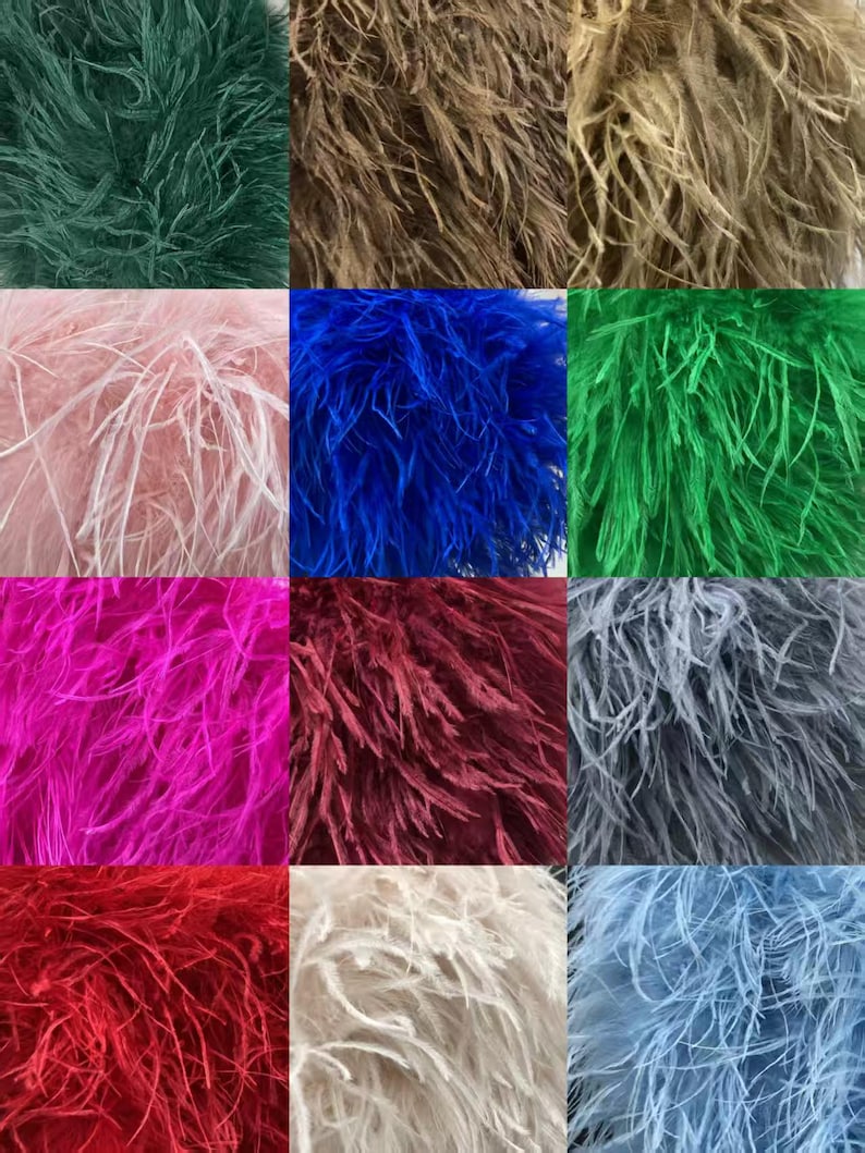 May include: A grid of colorful ostrich feather plumes in shades of green, brown, pink, blue, and red. The feathers have a soft, fluffy texture and are arranged in a square pattern. The colors range from dark to light, creating a visually appealing display.