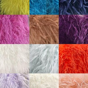 May include: A collection of colorful ostrich feathers in various shades. The colors include yellow, turquoise, navy, pink, brown, purple, white, light blue, orange, lavender, and peach. These feathers are suitable for crafting and decorative purposes.