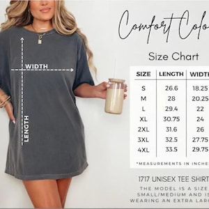 May include: Dark grey unisex tee shirt with a size chart. The chart shows measurements in inches for sizes S to 4XL. The model is wearing an extra large. The shirt is labeled "1717 UNISEX TEE SHIRT" and the brand is "Comfort Colors".