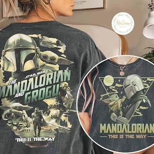 Peut inclure: T-shirt gris fonc&eacute; avec un graphisme de Star Wars repr&eacute;sentant "The Mandalorian et Grogu". Le design comprend le casque du Mandalorien, Grogu et la phrase "This is the Way".