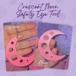 May include: Pink crescent moon safety eye tool with multiple circular holes. One is a keychain, the other is plain. The text "Crescent Moon Safety Eye Tool" is at the top of the image.