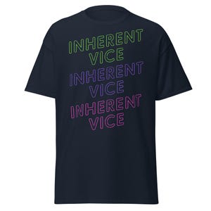 May include: A navy blue t-shirt with the text "INHERENT VICE" repeated three times in neon green, purple, and pink.