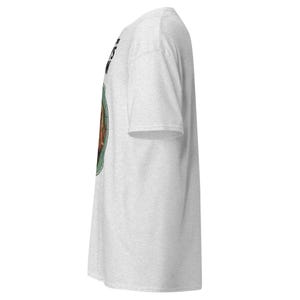 May include: A light gray t-shirt with a circular graphic on the front. The graphic features a brown image within a green circle, with black text above. The shirt has short sleeves and a crew neck.