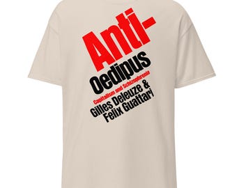 May include: A beige t-shirt with a red and black graphic print that says "Anti-Oedipus Capitalism and Schizophrenia Gilles Deleuze & Felix Guattari"