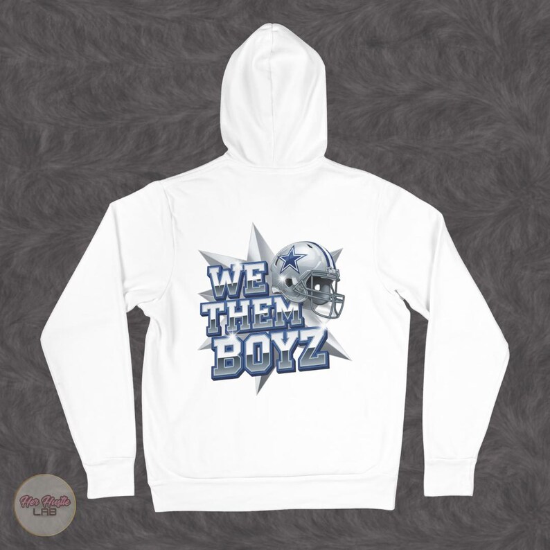 May include: White hoodie with a hood and long sleeves. The back features a graphic of a football helmet and the text "WE THEM BOYZ" in blue and silver. The design is set against a starburst.