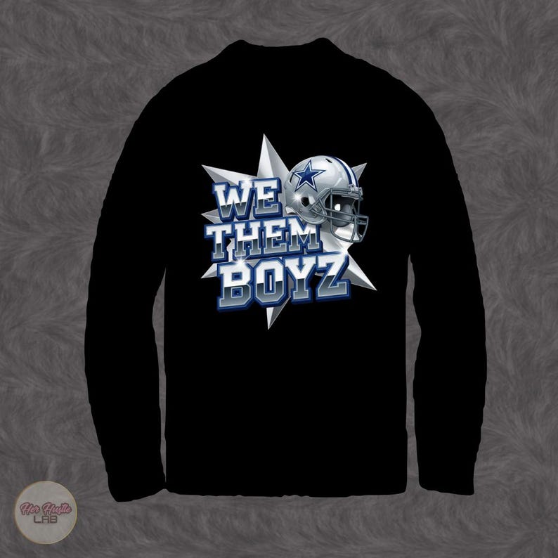 May include: Black long-sleeve shirt featuring the text "WE THEM BOYZ" in white and blue, with a football helmet graphic. The design includes a starburst background.
