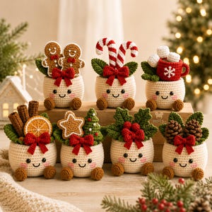 May include: Seven crocheted cream-colored pots with smiling faces, each featuring a unique holiday topper including gingerbread figures, candy canes, a mug with marshmallows, cinnamon sticks, orange slices, a star, a tree, holly, and pinecones.